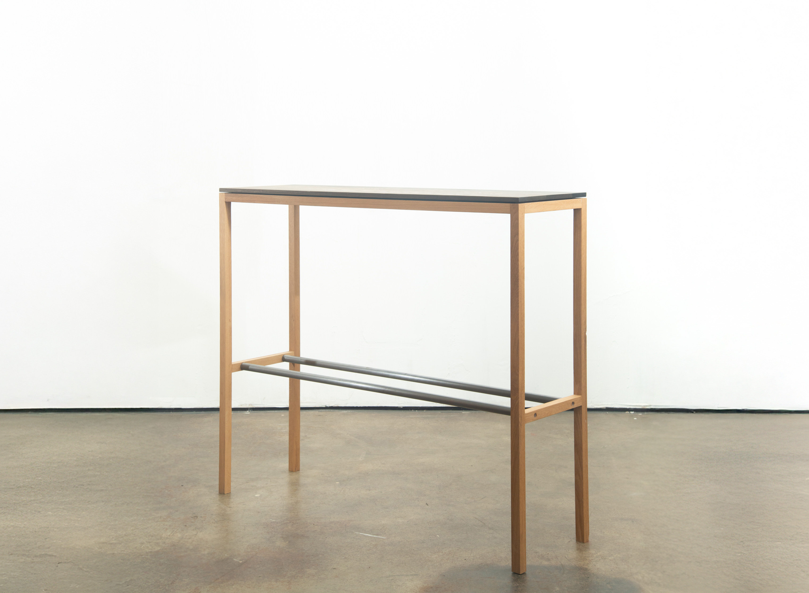 Bar console table on a white wall and concrete floor